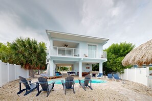 A two-story house with a balcony, a pool, and outdoor seating. - Cozy home with water access, private pool, dock, wifi, central a/c, balcony (Marathon)