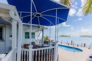 A covered outdoor area with a pool, a dining table, and chairs. - Dog-Friendly Home on the Water w/ Dock, Boat Access, Private Pool, & Free WiFi (Marathon)