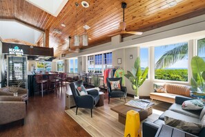 A spacious hotel lobby with a wooden ceiling, a bar area, seating arrangements, and large windows offering a view of the outdoors. - Coastal retreat with private balcony, pool, & easy beach access (Tavernier)