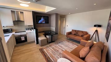 Deluxe Apartment, 4 Bedrooms, City View | Living area | 40-inch Smart TV with cable channels
