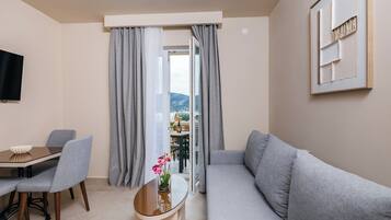 Standard Apartment, Balcony, Sea View | Living area | Flat-screen TV
