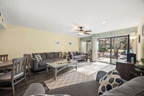 A living room with a sofa, coffee table, and dining area. - New Listing! Updated Luxury 2 BR 2.5 BA Golf Condo Near Ocean Bikes & Beach Gear (Hilton Head Island)