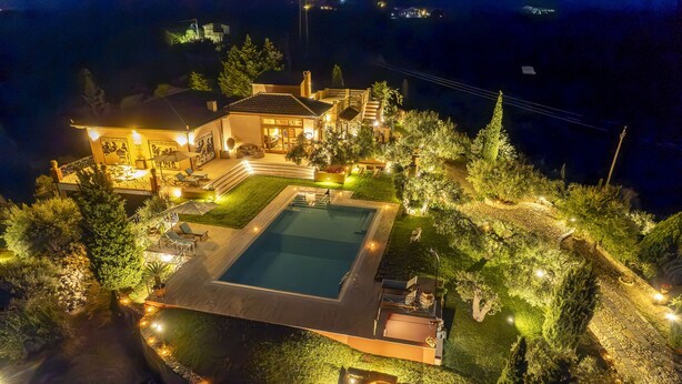 A well-lit residential property with a swimming pool, outdoor seating, and a landscaped garden. - Anticuum Gimnasium - Luxury Holiday Villa Sicily with infinity swimming pool (Terme)