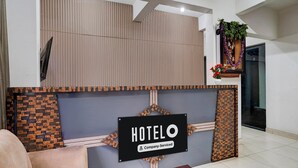 A hotel reception area with a sign reading 'HOTELO Company-Serviced.' - Deluxehotel Gurudev Residency (Bengaluru)