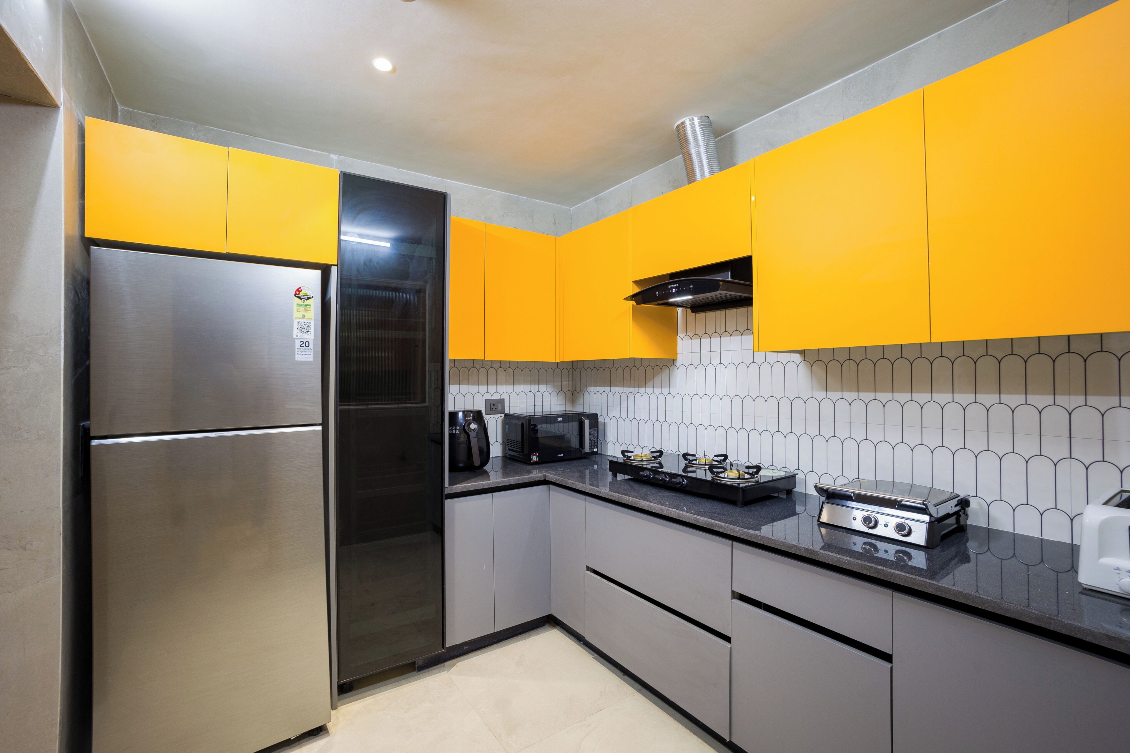 A modern kitchen with stainless steel appliances, a microwave, and a toaster.