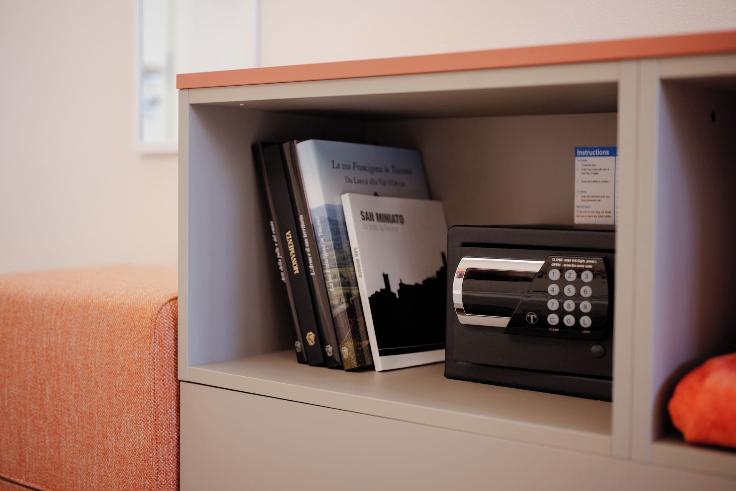 A shelf with books and a printer.