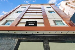 A multi-story building with a sign reading 'TOWNHOUSE.'