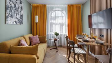 Superior Apartment, City View | Living area | 40-inch TV with cable channels