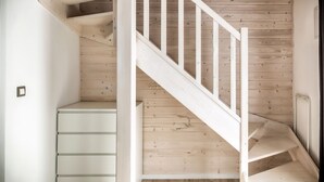 A wooden staircase with white railings leading to a landing. - Comfortable House With a Terrace, Sauna, Jacuzzi (Rewal)