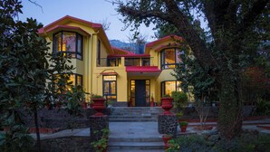A two-story house with a red roof, large windows, and a stone staircase leading to the front door. - Alaya Stays Thistle House 4 BHK Hideaway (Bhimtal)