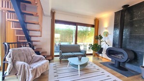 A living room with a sofa, armchair, coffee table, fireplace, and a staircase. - "Villa of Arts".House with the pool, minutes from ocean and not far from Lisbon (Corroios)