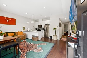 A modern kitchen with white cabinets, a stainless steel refrigerator, and a microwave. - 2BR 2BA DC Oasis Free Parking Near Capitol Hill (Washington)