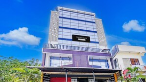 A multi-story building with a sign reading 'Townhouse & Company Services.' - Deluxeclassic Court (Patna)