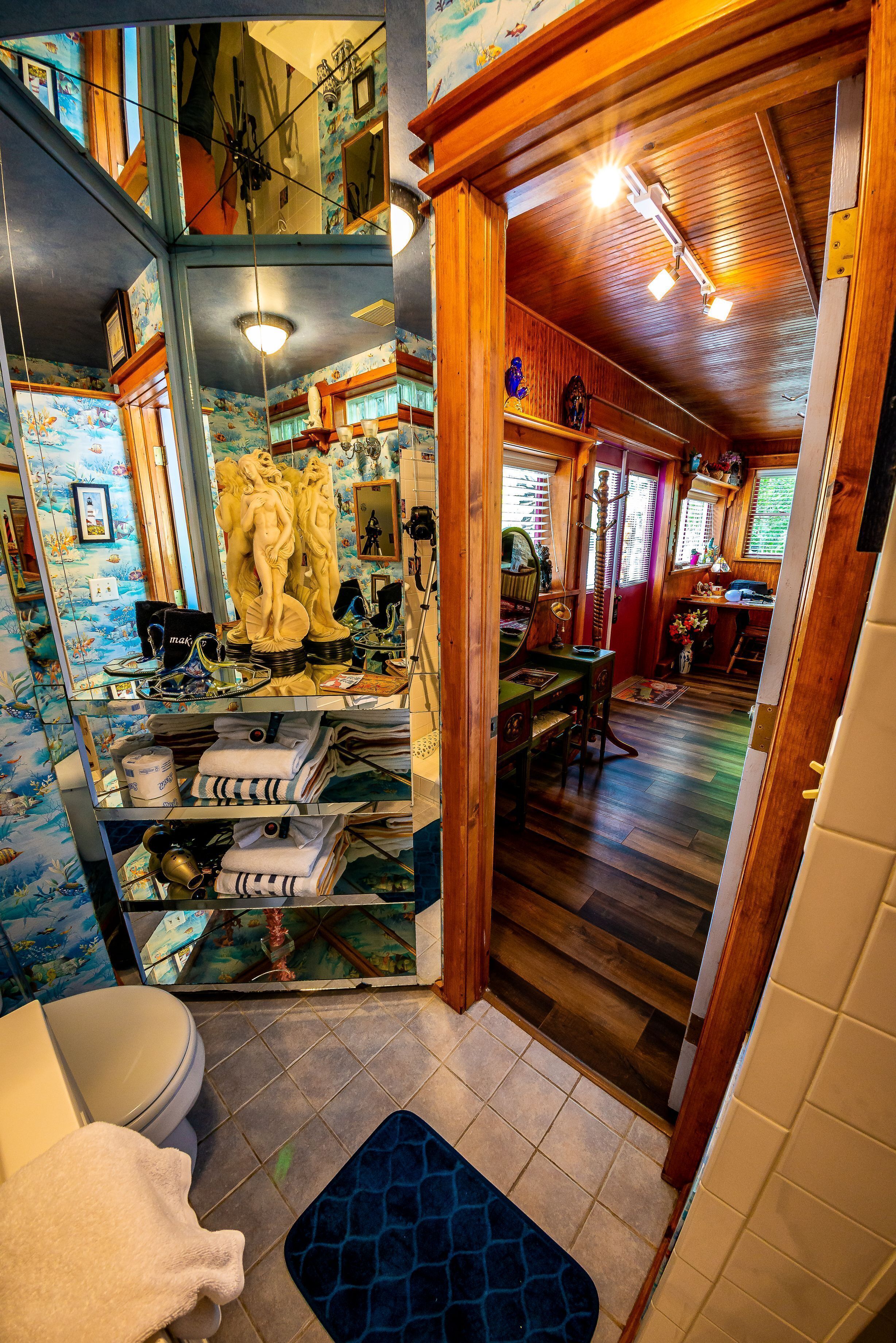 A bathroom with a toilet, sink, and mirror.