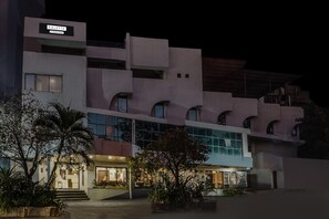 A modern building with a sign reading "PALETTE." It features a multi-story structure with large windows and a flat roof. - Deluxe Country Club (Surat)