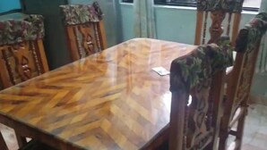 A dining table with a herringbone pattern, surrounded by wooden chairs with floral upholstery. - Casa Sweetie is your place to live, work or visit in the very heart of Jalatlaco. (Oaxaca de Juárez)
