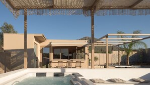 Area esterna moderna con vasca idromassaggio, pergola, posti a sedere e vista su una casa.