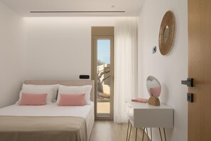 A bedroom with a bed, a bedside table, a mirror, and a door leading to a balcony. - Luxury Villa with Jacuzzi for 9 (Gouves)