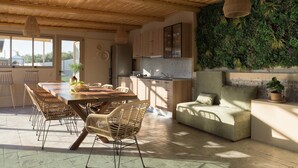Una cucina moderna con mobili in legno, un'area pranzo con un tavolo grande e sedie in vimini, e una parete verde con piante.