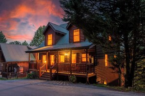 A log cabin with a porch, a staircase, and a metal roof. - *Relaxing 5BD Lodge w/ VIEWS | Games + Hot Tub* (Sevierville)