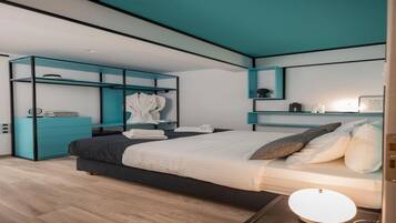 A modern bedroom with a bed, built-in storage, and a bedside table.