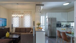 A modern apartment with a living room, dining area, and kitchen. - 10-Guest Countryside Villa with Barbecue (Heraklion)