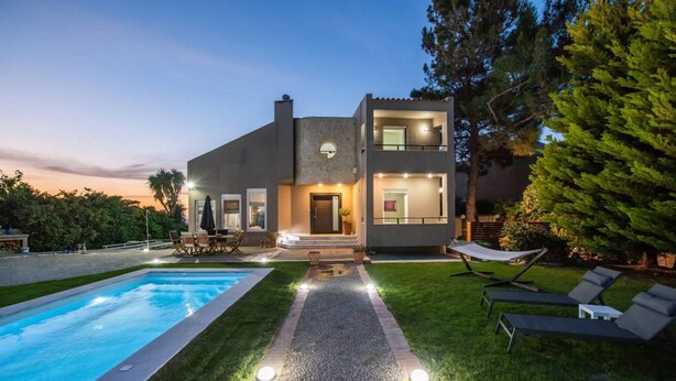 A modern two-story house with a swimming pool, outdoor seating, and a well-maintained lawn. - 10-Guest Countryside Villa with Barbecue (Heraklion)