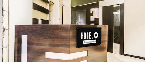 A reception desk with a sign reading 'HOTEL' and 'Company-Served.'