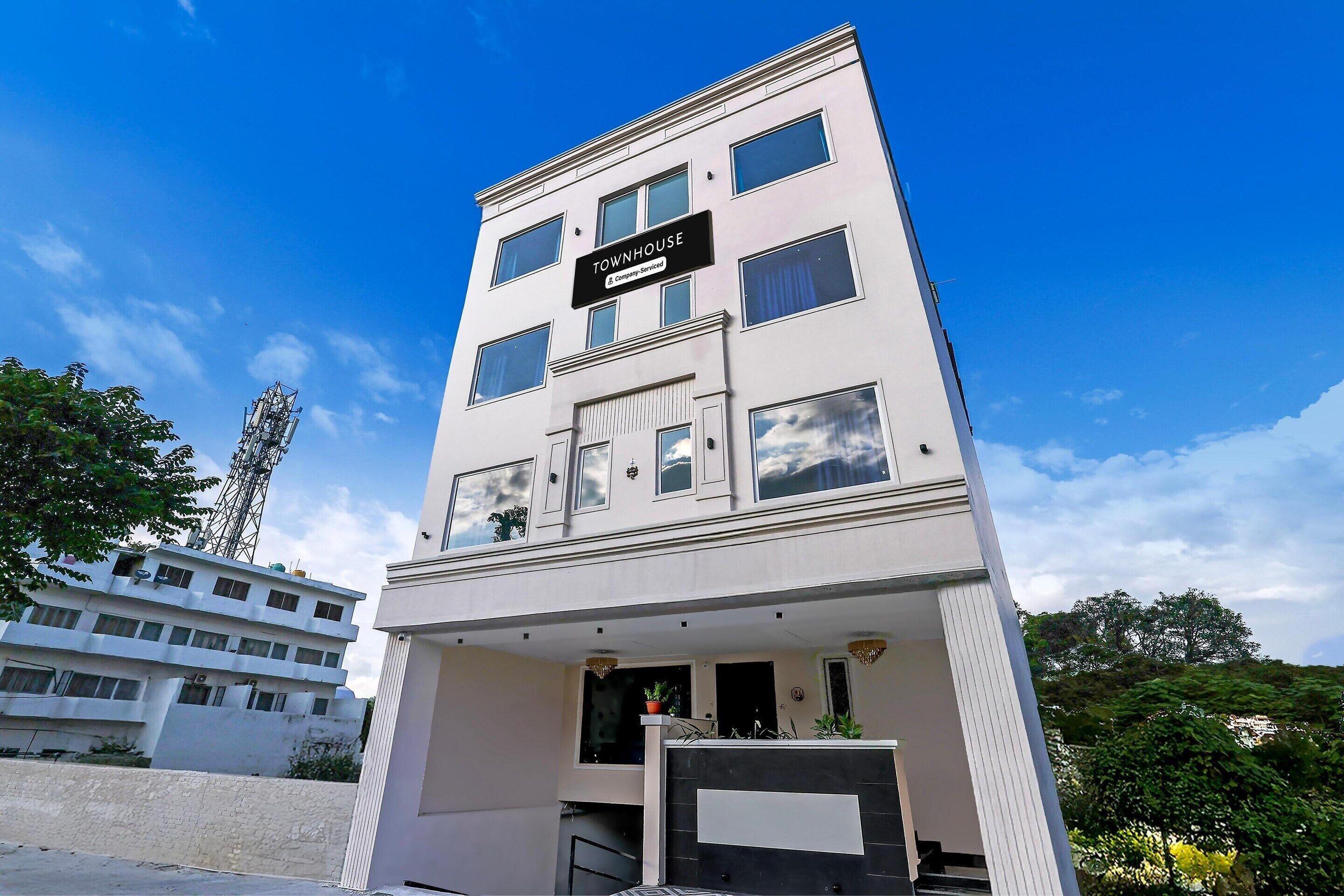 A multi-story building with a sign reading 'TOWNHOUSE.'