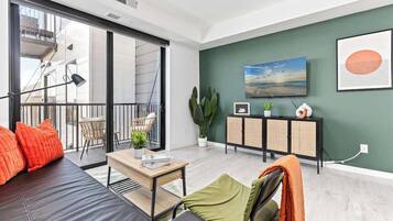 A modern living room with a sofa, a coffee table, a TV, and a cabinet.