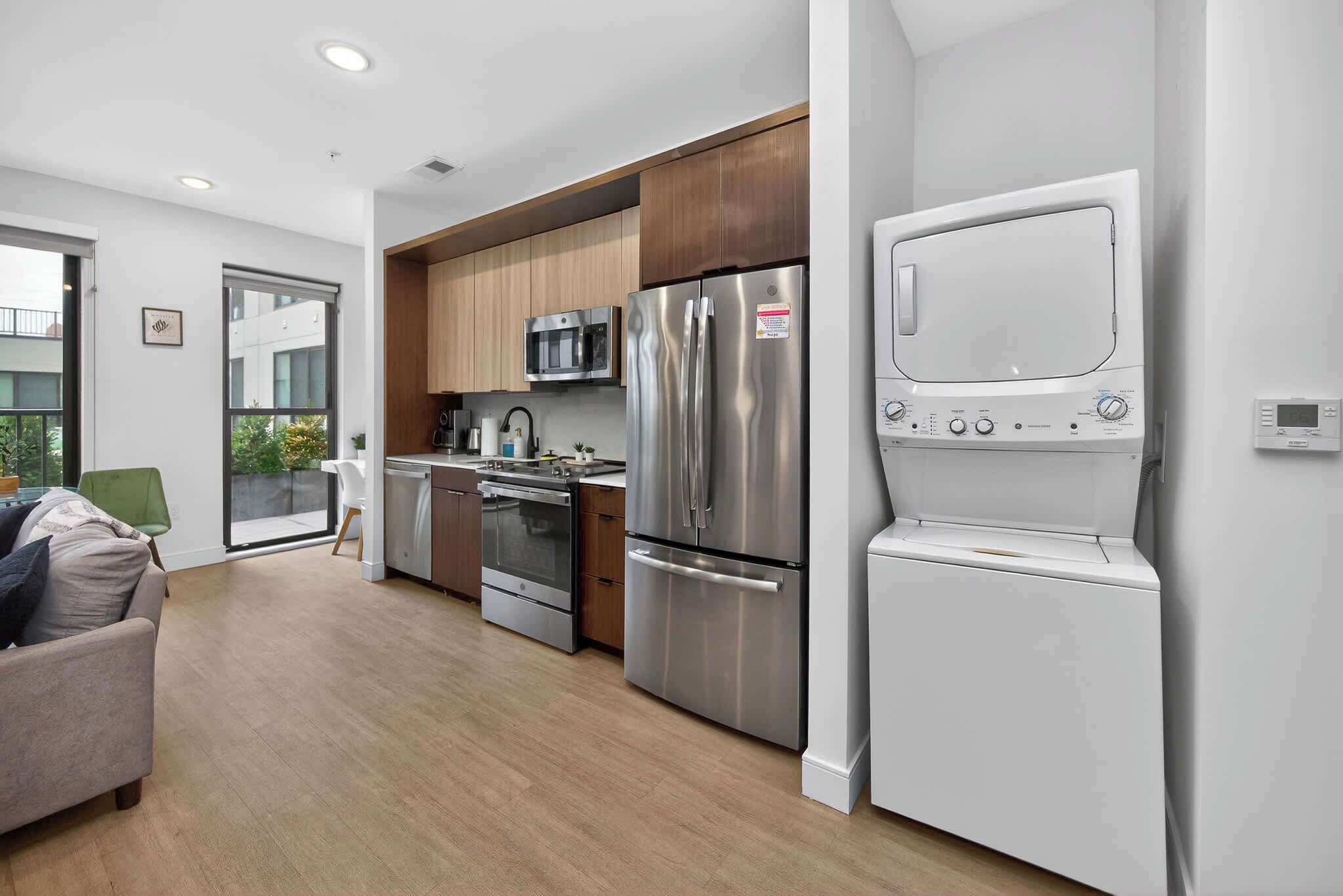A modern kitchen with stainless steel appliances, a built-in microwave, and a white oven.