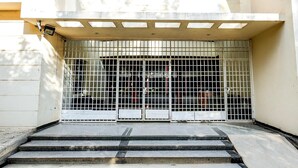 A gated entrance with steps leading up to a building. - Super Townhouse City Center Ernakulam (Kanayannur)