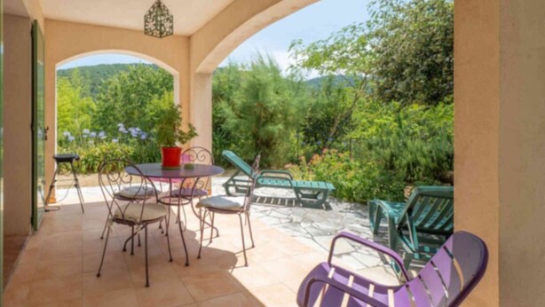 A covered patio with outdoor furniture, a table, and a hanging light fixture. - Pascaline, Holiday Cottage for 4 People (Le Bar-sur-Loup)