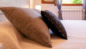 A bed with two pillows, one plain and one with a geometric pattern. - Pascaline, Holiday Cottage for 4 People (Le Bar-sur-Loup)