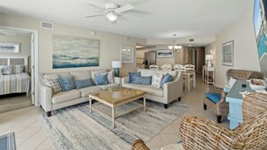 A spacious living room with a sofa, coffee table, and a ceiling fan. - Ocean Bay Club 1510-4 Bedroom-Indoor/Outdoor Pools (North Myrtle Beach)