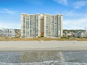 A high-rise hotel with multiple floors, balconies, and a beach view. - Ocean Bay Club 1510-4 Bedroom-Indoor/Outdoor Pools (North Myrtle Beach)