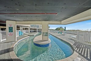 A pool area with a hot tub, lounge chairs, and a view of the beach. - Ocean Bay Club 1510-4 Bedroom-Indoor/Outdoor Pools (North Myrtle Beach)