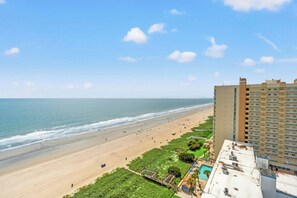 A beach view with a hotel building adjacent to the shore. - Ocean Bay Club 1510-4 Bedroom-Indoor/Outdoor Pools (North Myrtle Beach)