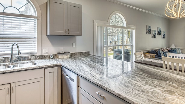 A kitchen with a marble countertop, a built-in sink, and a window with blinds. - Family Favorite 1st Floor Pool Golf (Myrtle Beach)