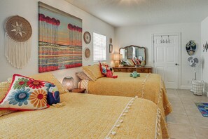A bedroom with two beds, a large painting, a mirror, and a door. - Steps to Sand! Singer Island Getaway w/ Bikes (Singer Island)