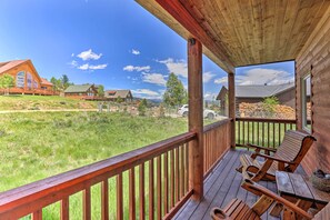 A wooden deck with a view of a grassy area and houses in the background. - 2 Mi to Granby Ranch: Granby Home w/ Hot Tub! (Granby)