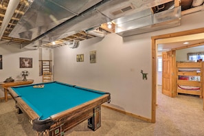A pool table in a room with a wooden door, a fan, and a ladder. - 2 Mi to Granby Ranch: Granby Home w/ Hot Tub! (Granby)