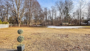 A park with bare trees, a snow patch, and a potted topiary. - Pet-friendly Home w/ Patio: 4 Mi to Saratoga Spa! (Saratoga Springs)