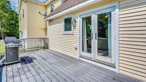 A house with a covered deck, a satellite dish, and a sliding glass door. - Explore the White Mountains! Spacious Rural Home (Thornton)