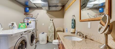 A laundry area with a washing machine, dryer, and a water heater.
