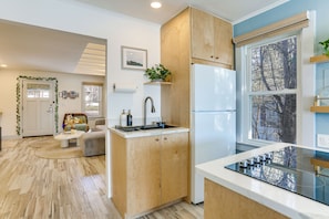 A modern kitchen with wooden cabinets, a built-in stove, and a refrigerator. - Lakefront Living By Mtn Creek! Modern Home w/ Deck (Sussex)