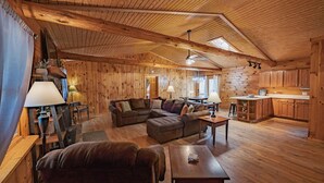 L’intérieur d’une cabane en rondins comprend un salon, un coin repas et une cuisine.