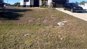 A modern two-story house with a garage, a driveway, and a parked car. - Spacious 4-bedroom tranquil escape Lehigh Acres Near the Forum (Lehigh Acres)
