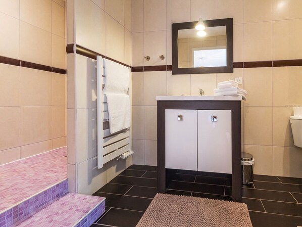 A bathroom with a white sink, a mirror, a towel rack, and a toilet. - Room with private terrace (Guérande)