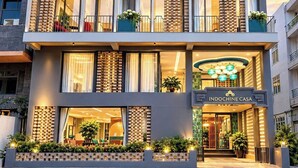 Un hôtel à plusieurs étages doté de balcons, d’un espace de réception et d’une enseigne indiquant « INDOCHINE CASA ».